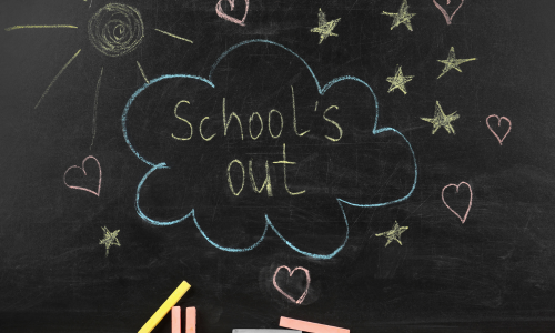 "School's out" written in white on a blackboard, surrounded by a blue cloud shaped bubble and some hearts and stars 